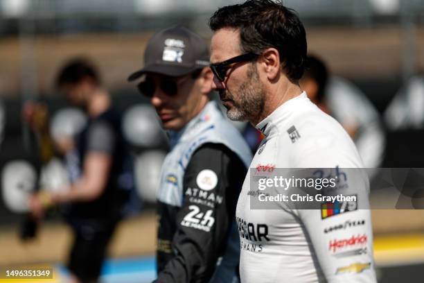 Jimmie Johnson, driver of the NASCAR Next Gen Chevrolet ZL1 talks with Simon Pagenaud prior to the 100th anniversary of the 24 Hours of Le Mans at...