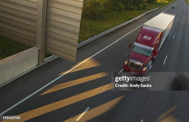 a semi-truck and trailer on a highway at dusk - chelsea michigan stock pictures, royalty-free photos & images