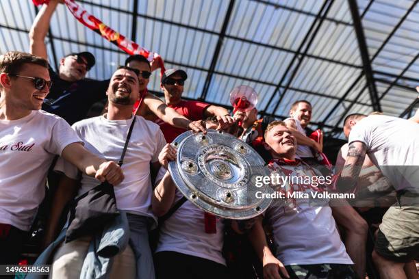 Fans from Muenchen celebrate the winning of the championship with trophy after the Bundesliga match between 1.FC Koeln and FC Bayern Muenchen at...