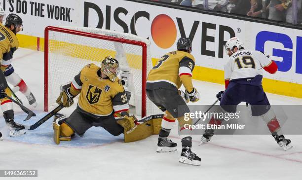 Adin Hill of the Vegas Golden Knights blocks a shot by Matthew Tkachuk of the Florida Panthers as Brayden McNabb of the Golden Knights defends in the...