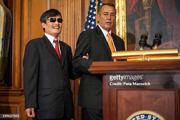 Speaker of the House John Boehner leads Chinese human rights activist Chen Guangcheng to speak to the press following a meeting at the U.S. Capitol...