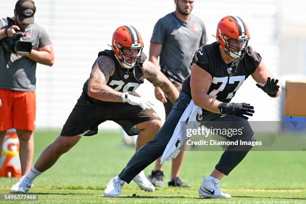 Wyatt Teller and Jack Conklin of the Cleveland Browns run a drill during the Cleveland Browns OTAs at CrossCountry Mortgage Campus on May 31, 2023 in...