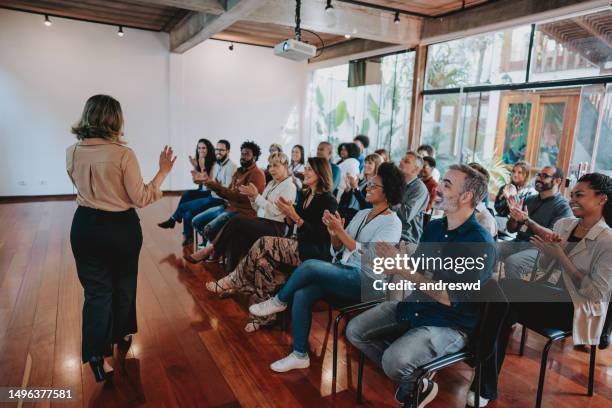 woman presenting at a conference - auditorium presentation stock pictures, royalty-free photos & images