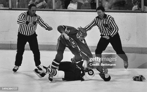 The Montreal Canadiens' Chris Nilan draws back his fist to land a punch on the Philadelphia Flyers' Daryl Stanley in the National Hockey League's...