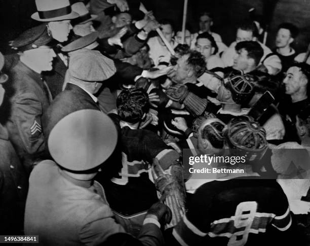 Police officers and spectators join in a fight between players of the Detroit Red Wings and Montreal Canadiens in Detroit, Michigan, March 2nd 1936....