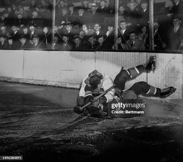 Neil Colville of the New York Rangers has a glove pushed in his face by Ray Getliffe of the Montreal Canadiens in a third period brawl at Madison...