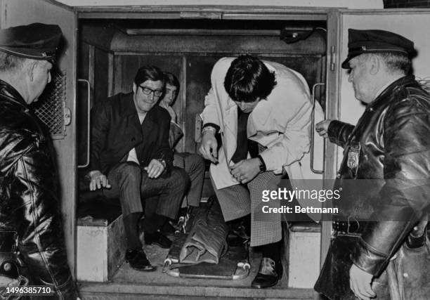 The St Louis Blues' coach Al Arbour and other Blues players pictured in a police van after being arrested for disorderly conduct during an ice hockey...