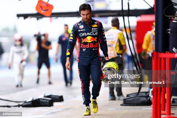 11th Placed qualifier Sergio Perez of Mexico and Oracle Red Bull Racing shows his dejection as he walks in the pit lane during qualifying ahead of...