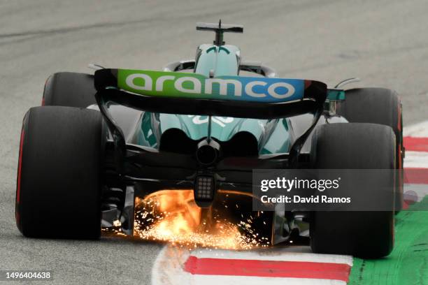 Sparks fly behind Lance Stroll of Canada driving the Aston Martin AMR23 Mercedes on track during qualifying ahead of the F1 Grand Prix of Spain at...