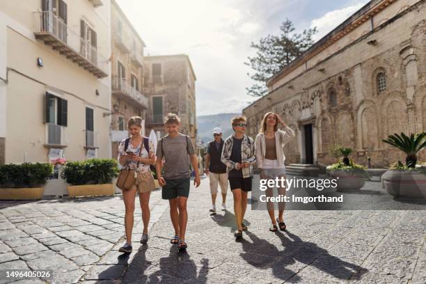 multi generation family walking in a charming piazza of tropea - calabria stockfoto's en -beelden