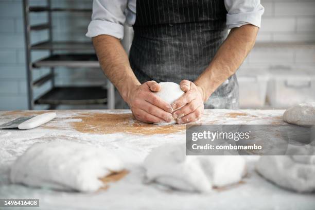 hands of a chef kneading a dough on a kitchen counter to make artisan bread - wheat flour stock pictures, royalty-free photos & images