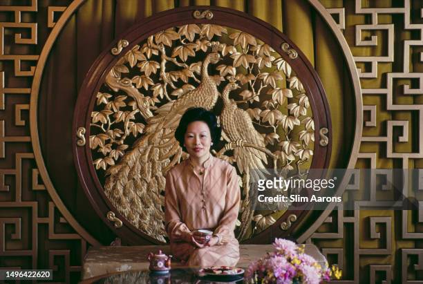 Margaret Chan Wen Hsien framed by the Phoenix Screen in the Executive Suite of the Singapore Mandarin Hotel, 1981.