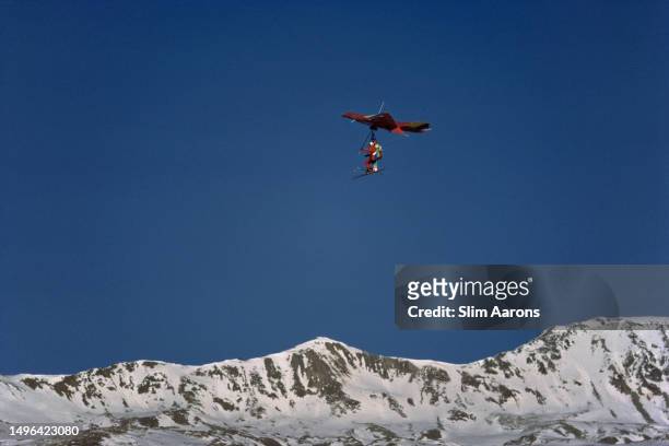 Skiers using a hang glider in St. Moritz, Switzerland, 1989.