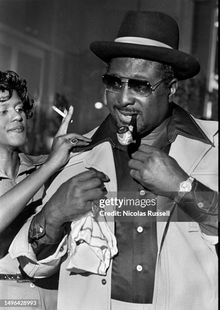 Blues Singer and guitarist, Albert King poses with an admirer in 1976 at Antone's in Austin Texas.