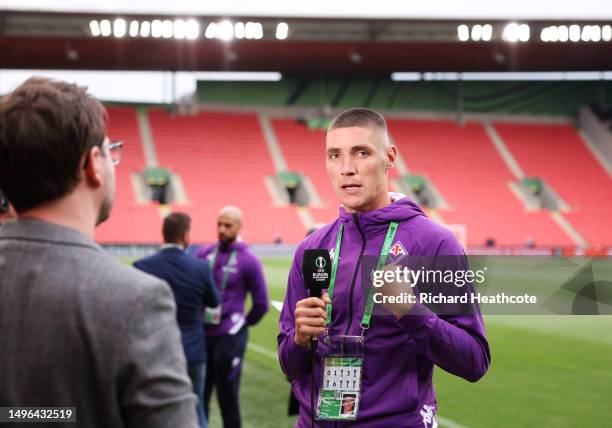 Nikola Milenkovic of ACF Fiorentina is interviewed as they inspect the pitch ahead of the UEFA Europa Conference League 2022/23 final match between...