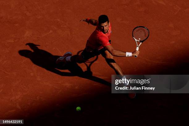 Novak Djokovic of Serbia plays a backhand against Karen Khachanov during the Men's Singles Quarter Final match on Day Ten of the 2023 French Open at...