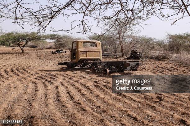 The remains of vehicles left behind after the war for Independence sit in a section of some of the harvested farmlands around the city of Barentu as...