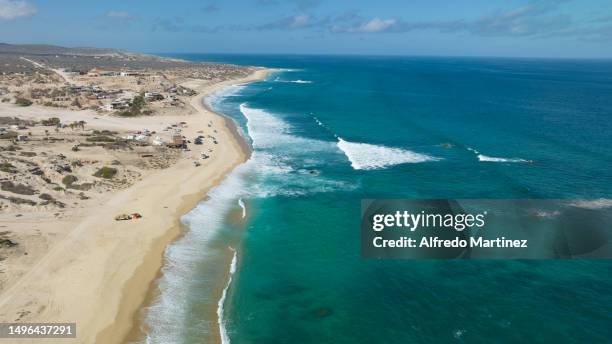 In this aerial view, surfers and tourists enjoy the waves and La Fortuna beach located in the Eastern Cape on June 02, 2023 in Los Cabos, Mexico....