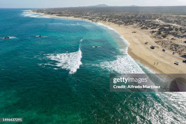 In this aerial view, surfers and tourists enjoy the waves and La Fortuna beach located in the Eastern Cape on June 02, 2023 in Los Cabos, Mexico....