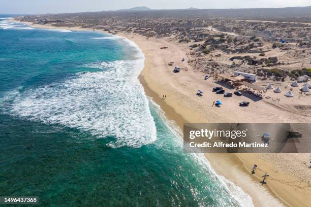 In this aerial view, surfers and tourists enjoy the waves and La Fortuna beach located in the Eastern Cape on June 02, 2023 in Los Cabos, Mexico....