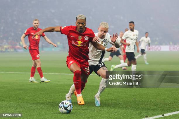 Philipp Max of Eintracht Frankfurt battles for possession with Benjamin Henrichs of RB Leipzig during the DFB Cup final match between RB Leipzig and...