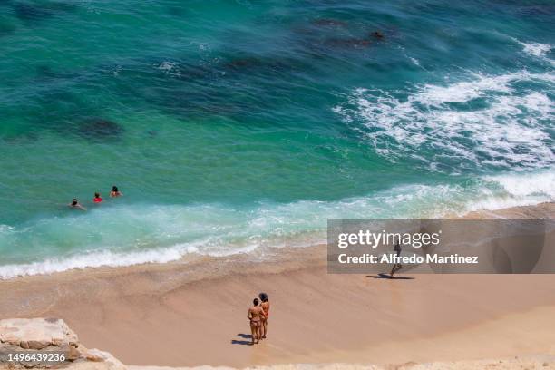 Surfers and tourists enjoy the waves at Acapulquito beach located in San Jose del Cabo on June 03, 2023 in Los Cabos, Mexico. Big-wave conditions in...