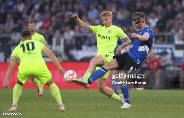 Bjarke Halfdan Jacobsen of Wiesbaden is challenged by Fabian Klos of Bielefeld during the Second Bundesliga playoffs second leg match between DSC...