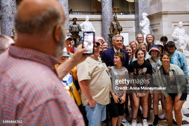 Speaker of the House Kevin McCarthy greets tourists in Statuary Hall as he walks to the floor of the House Chambers at the U.S. Capitol Building on...
