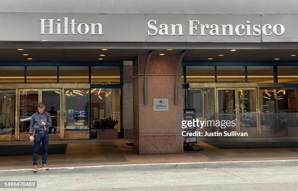 Guest stands in front of the Hilton San Francisco Union Square on June 06, 2023 in San Francisco, California. As San Francisco continues to struggle...
