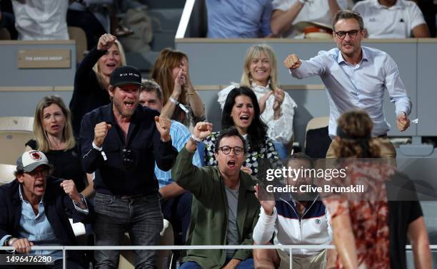 Fans celebrate a point with Stefanos Tsitsipas of Greece against Carlos Alcaraz of Spain during the Men's Singles Quarter Final match on Day Ten of...