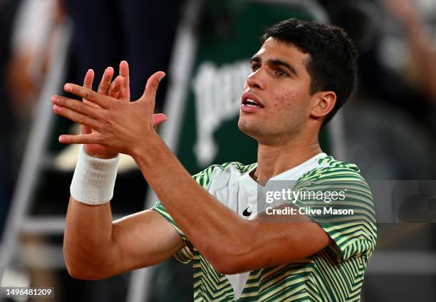 Carlos Alcaraz of Spain celebrates winning match point against Stefanos Tsitsipas of Greece during the Men's Singles Quarter Final match on Day Ten...