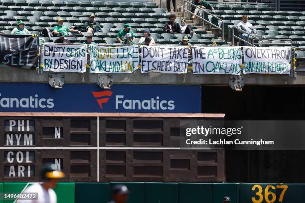 Oakland Athletics fans display signs during the game against the Atlanta Braves at RingCentral Coliseum on May 31, 2023 in Oakland, California. The...