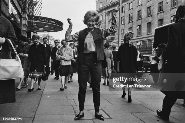 Model Cherry Goff wearing clothing by Lybro Ltd Denim Jeans, outside the Hotel Café Royal on Regent Street, London, 12th Nov 1963.
