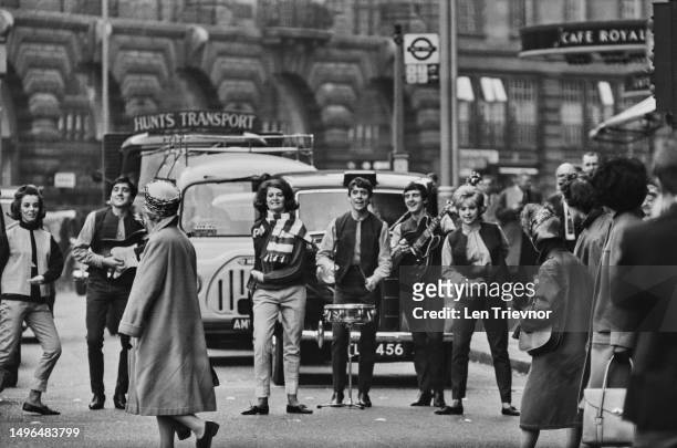 Fashion models and members of British Merseybeat band, The Swinging Blue Jeans, in a photo shoot to promote Lybro Ltd Denim Jeans outside the Hotel...