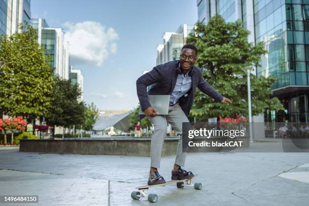 african american young male entrepreneur on longboard - accelerate business stock pictures, royalty-free photos & images