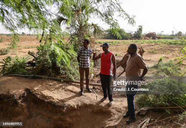 Communications Officer at the Ministry of Agriculture Andy Meskel Bererhe speaks with local farmer Efraim Tesfolde Terfe and Head of the Subzone at...