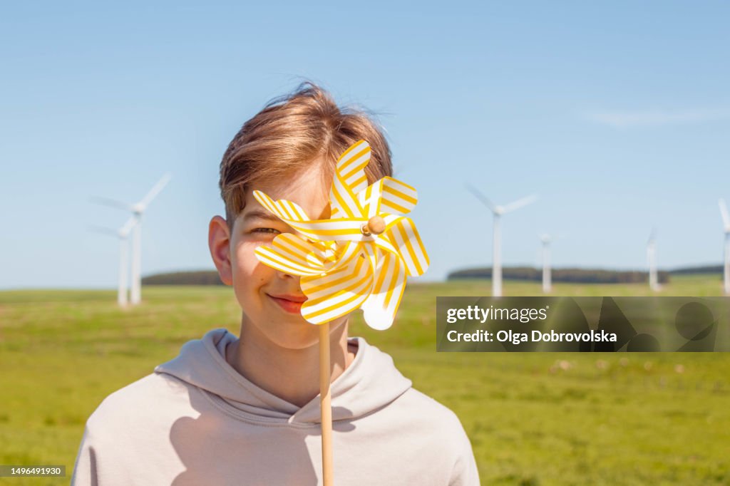 Windmill Boy Portrait Of A Teenage Boy Covering His Eye With A Small Windmill While ...