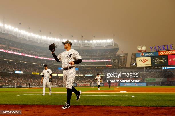 General view of hazy conditions resulting from Canadian wildfires as Anthony Rizzo of the New York Yankees jogs to the dugout during the second...