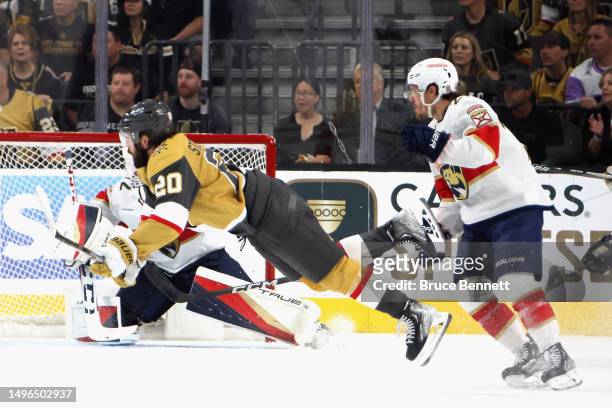 Chandler Stephenson of the Vegas Golden Knights is tripped up by Nick Cousins of the Florida Panthers in Game Two of the 2023 NHL Stanley Cup Final...
