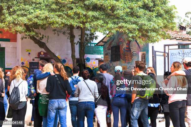 bogota, colombia - tourists listen to a tourist guide on plaza chorro de quevedo in the candelaria district - plaza del chorro de quevedo stock pictures, royalty-free photos & images