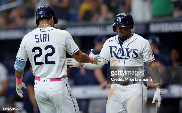 Jose Siri of the Tampa Bay Rays is congratulated after hitting a home run in the seventh inning during a game against the Minnesota Twins at...