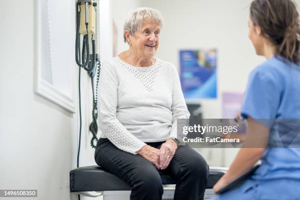 senior at a medical appointment - clinic stock pictures, royalty-free photos & images