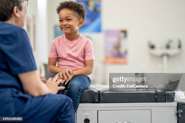 young boy at the doctors - prevent illness stock pictures, royalty-free photos & images