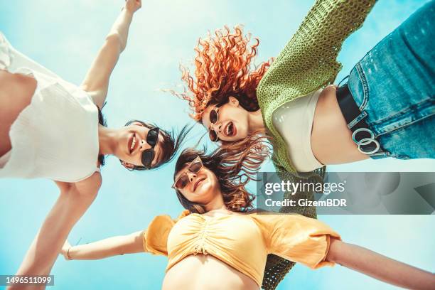 three girlfriends having fun with hands up - blue sunglasses stock pictures, royalty-free photos & images