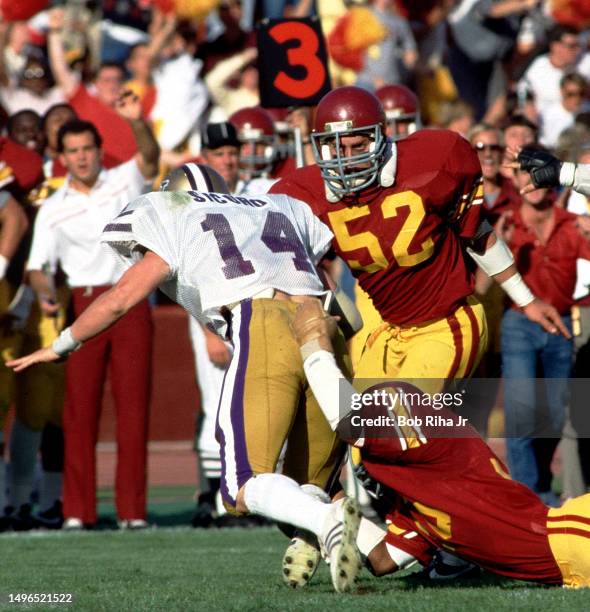 University of Washington Quarterback Paul Sicuro under pressure from USC Linebacker Jack Del Rio during game action between University of Southern...