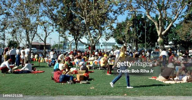 Football fans tailgate with baskets of food and drinks outside Los Angeles Coliseum before game action between University of Southern California and...