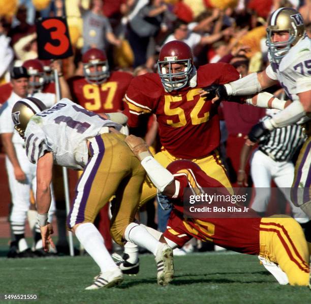 University of Washington Quarterback Paul Sicuro under pressure from USC Linebacker Jack Del Rio during game action between University of Southern...