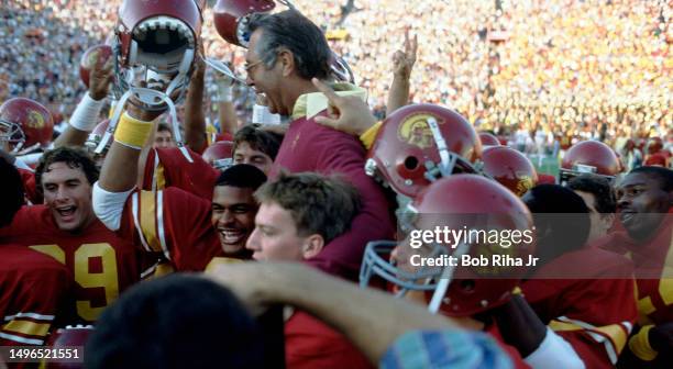 Victorious USC Head Coach Ted Tollner is carried off the field by team members after game between University of Southern California and University of...