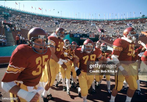 Football team hits the field before game between University of Southern California and University of Washington at Los Angeles Coliseum, November 10,...