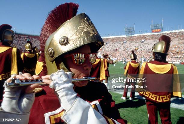 Trojan band member plays flute before game action between University of Southern California and University of Washington at Los Angeles Coliseum,...